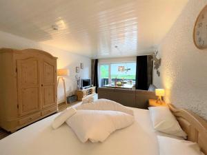 a bedroom with a bed with white pillows and a window at Appartement An der Ach - 15 in Pfronten