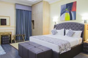 a hotel room with a large bed and a fireplace at BON Hotel Asokoro Residence in Abuja