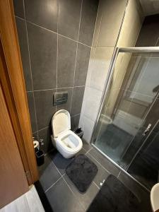 a small bathroom with a toilet and a shower at Kartepe Dedeman’da Rezidans in Kartepe