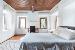 a bedroom with a large bed with a wooden ceiling at 18th Century Renovated Central Stone House, Terrace, Free Fast Wi-Fi in Bodrum City