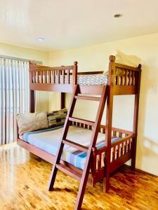 two bunk beds in a room with wooden floors at Elliannah Pines Hotel in Baguio