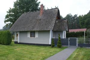 ヤロスワビエツにあるPiastogród 2の茅葺き屋根の小さな白い家