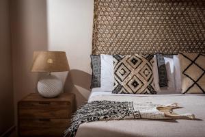 a bedroom with a bed and a lamp on a night stand at Creta Blue Boutique Hotel in Hersonissos