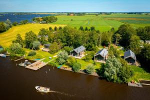 an aerial view of an island in the water with houses at Pean-buiten Waterlodges in Nes