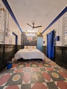 a bedroom with a bed and a tiled floor at Dylan Cafe And Guest House in Jodhpur