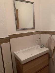 a bathroom with a white sink and a mirror at Altenhauser Hof in Kössen