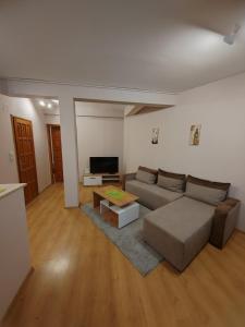 a living room with a couch and a table at Stella Apartment in Karaburma