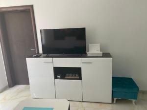 a white entertainment center with a flat screen tv at Elite in Ostrovo