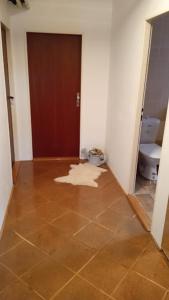 a bathroom with a tile floor and a toilet at Apartmán 6 km od centra Banskej Bystrice in Banská Bystrica