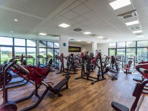 a gym with a lot of treadmills and machines at Best Western Parkhotel Hagenberg in Hagenberg im Mühlkreis