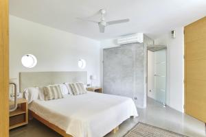 a white bedroom with a bed and a closet at Villa Cosima - San Antonio in San Antonio