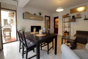 a dining room with a table and chairs and a living room at JACINTO 2 Playa Fuengirola in Fuengirola