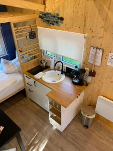 a bathroom with a sink and a bunk bed at Tiny House Möhne im PIER9 Tiny House Hotel in Hamm