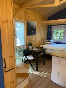 a room with a bed and a desk in a cabin at Tiny House Möhne im PIER9 Tiny House Hotel in Hamm