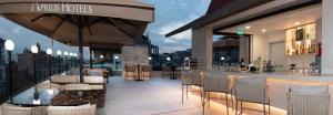 a restaurant with a bar with chairs and an umbrella at Aprilis Deluxe Hotel in Istanbul