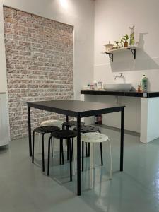a black table and chairs in a kitchen with a sink at Homestay "Feel at Home" Near A Famosa & Jonker Street for 4-7 people in Melaka