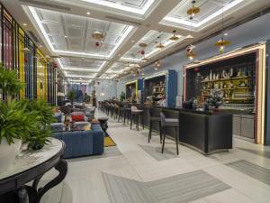 a bar in a restaurant with chairs and a counter at Vinpearl Wonderworld Phu Quoc in Phu Quoc