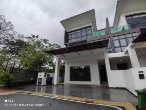 a house with a parking lot in front of it at Mawar Villa By Malvacae Homestay Shah Alam in Shah Alam