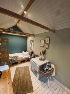 a living room with a bed and a table at Tiny House Werse im PIER9 Tiny House Hotel in Hamm