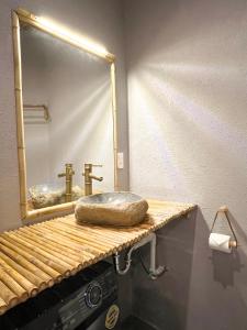 a bathroom with a sink and a mirror at Song Anh Indochina Studios Pasteur in Ho Chi Minh City