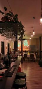 a restaurant with a bar with wine glasses at Forest Inn in Izvorani
