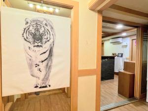 a painting of a tiger on a wall in a hallway at Cocoa Guesthouse in Seoul