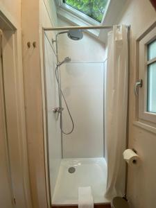 a bathroom with a shower with a sink and a toilet at Tiny House Lippe im PIER9 Tiny House Hotel in Hamm