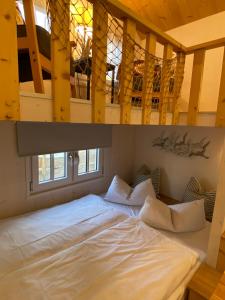 a large bed in a room with a loft at Tiny House Lippe im PIER9 Tiny House Hotel in Hamm