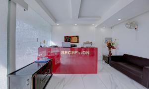 a reception desk in a room with a red partition at Treebo Trend Rockland Zirakpur in Chandīgarh