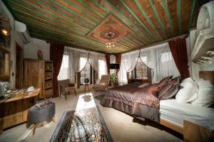 a bedroom with a large bed with a wooden ceiling at Serene Premium Stone House in Nevsehir