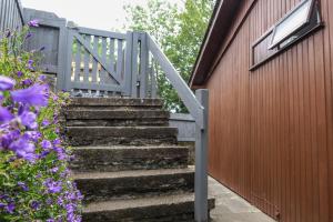 a set of stairs next to a red building at Riverside Chalet in heart of Lampeter, West Wales in Lampeter