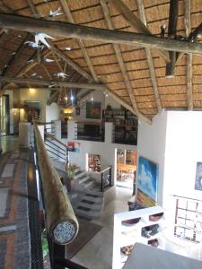 a room with stairs and a large wooden ceiling at Utopia in Africa Guest Villa in Nelspruit