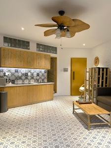 a living room with a ceiling fan and a table at Song Anh Indochina Studios Pasteur in Ho Chi Minh City