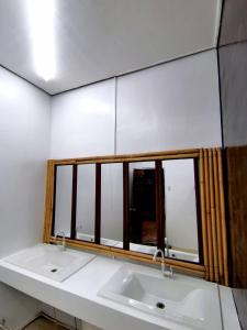 a bathroom with a sink and a window at Big Paul Hostel in El Nido