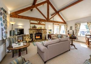 a living room with a couch and a fireplace at The Shippons in Abersoch