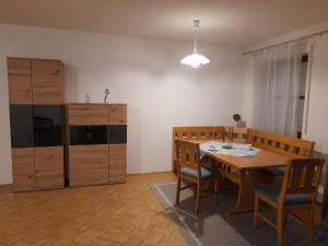 a dining room with a table and wooden chairs at Ferienwohnung Paul in Bad Reichenhall