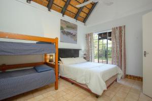 a bedroom with a bunk bed and a window at NJIRI LODGE - Your part of Africa in Marloth Park