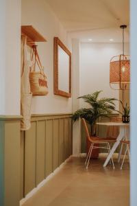 a dining room with a table and chairs and a mirror at Casa Los Yayos by Nomad Stays in Altea