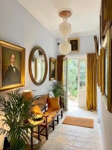a living room with a couch and a portrait of a man at Le Clos Saluces in Avignon