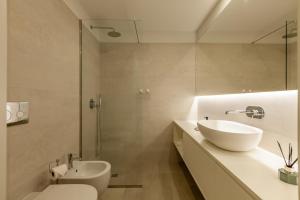 a bathroom with a sink and a toilet and a shower at Boavista Collection Studio - Minho's Guest in Braga