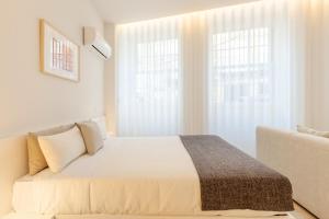 Ένα ή περισσότερα κρεβάτια σε δωμάτιο στο Boavista Collection Studio by Sé Apartamentos