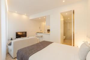Ένα ή περισσότερα κρεβάτια σε δωμάτιο στο Boavista Collection Studio by Sé Apartamentos