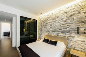 A bed or beds in a room at Acquarella Resort Suite