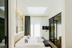 A bed or beds in a room at Acquarella Resort Suite