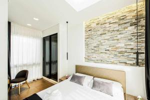 A bed or beds in a room at Acquarella Resort Suite
