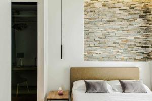 A bed or beds in a room at Acquarella Resort Suite
