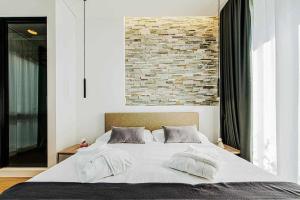 A bed or beds in a room at Acquarella Resort Suite