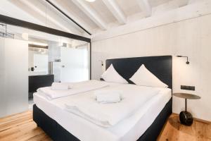 a bedroom with a large white bed with white pillows at Luxus Penthouse Zentral by A-Appartments in Brand +43 photos