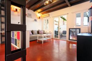 a living room with a couch and a table at Livemálaga Cervantes Attic & Terrace in Málaga