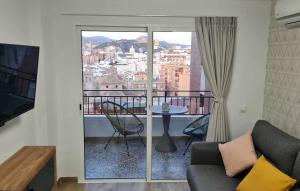 a living room with a couch and a balcony at Mirador La Catedral in Málaga